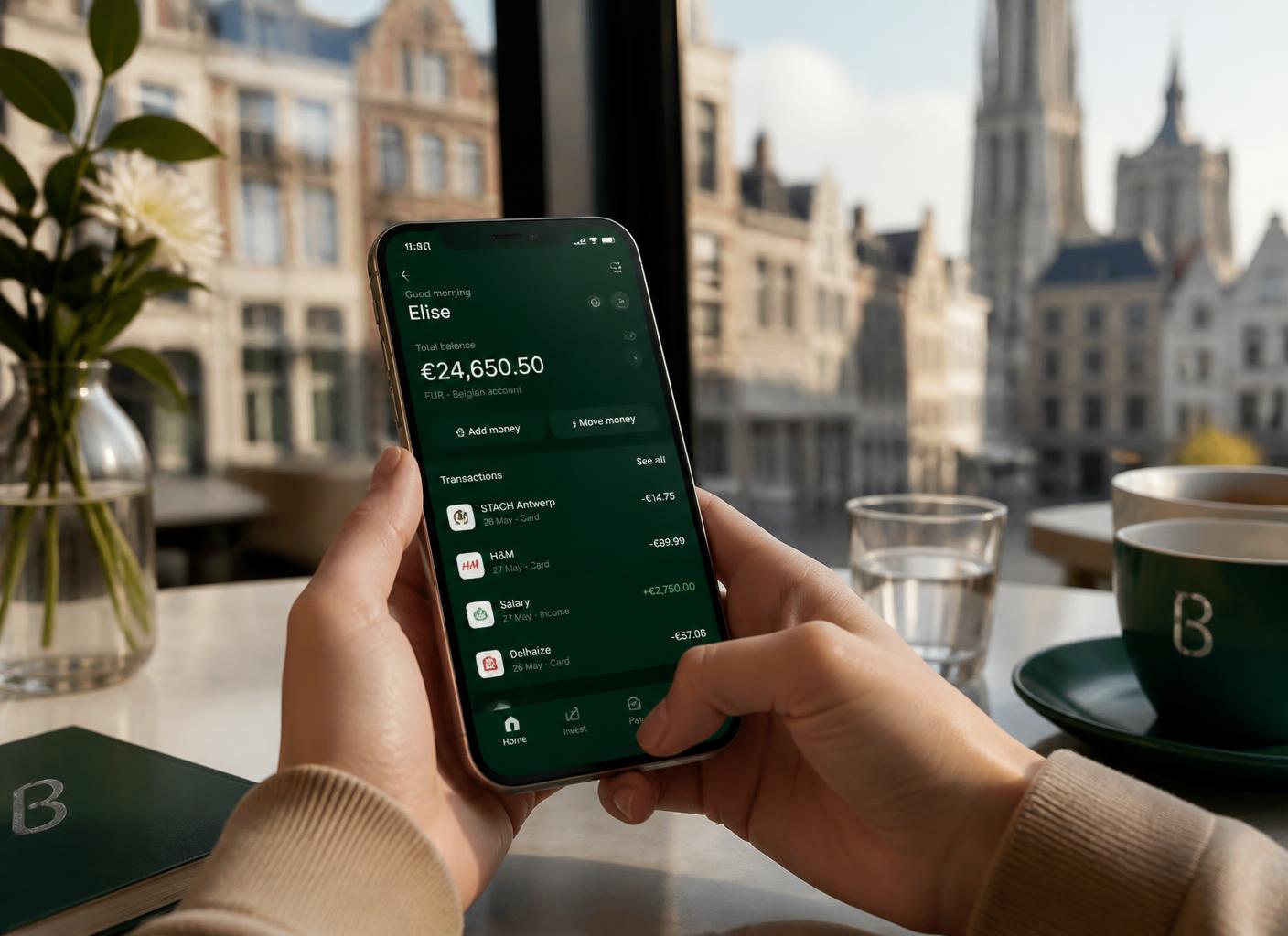 A customer checking her Schelden Bank balance on her phone at an Antwerp café